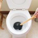White toilet and black plunger, tools for maintaining plumbing by Bud's Plumbing & Repair Service.