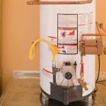 Water heater with copper piping, safety panel, and drain valve for effective plumbing maintenance and water conservation.